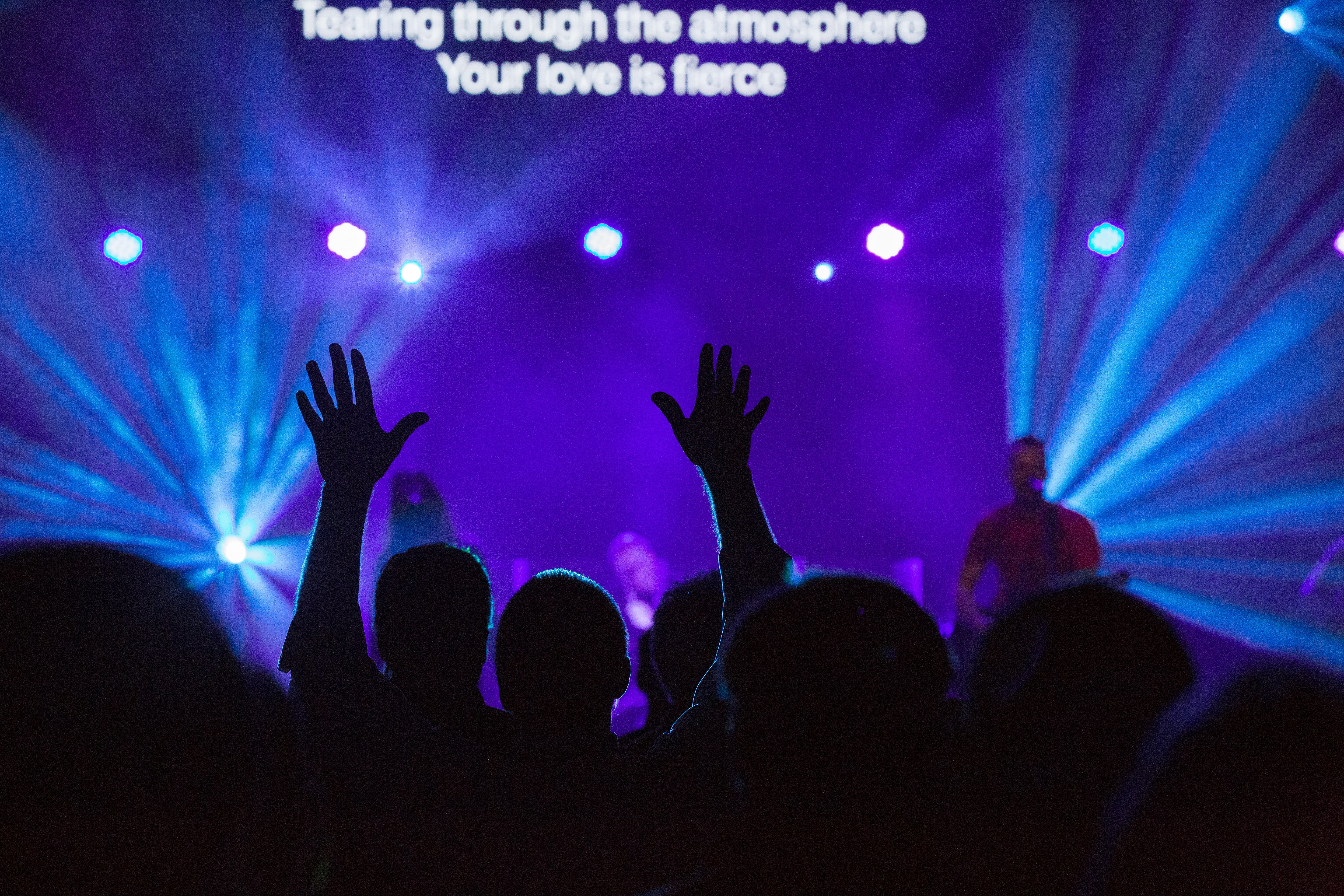 silhouette of people against purple background